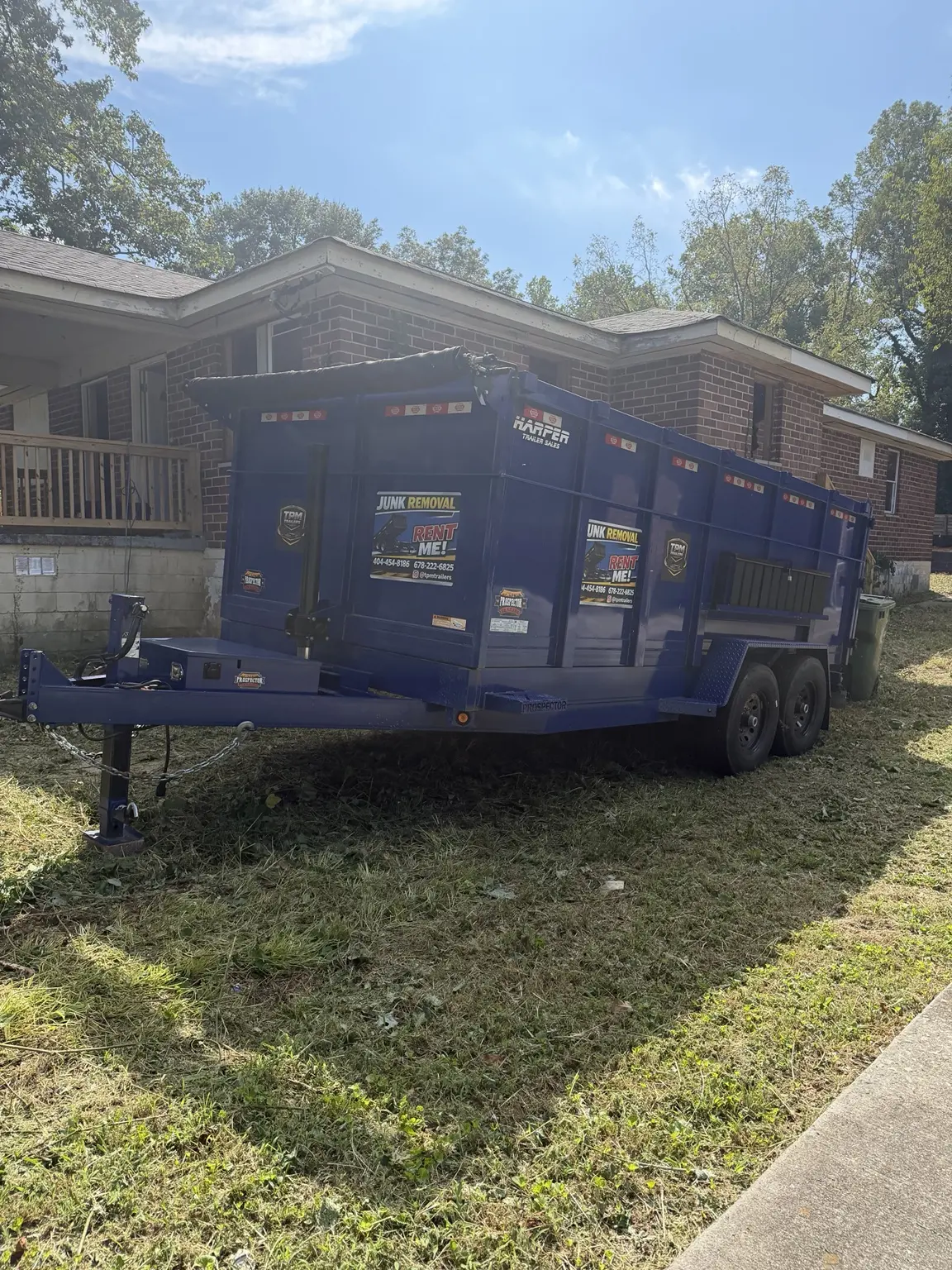 TPM Trailers dump trailer positioned beside Atlanta renovation building