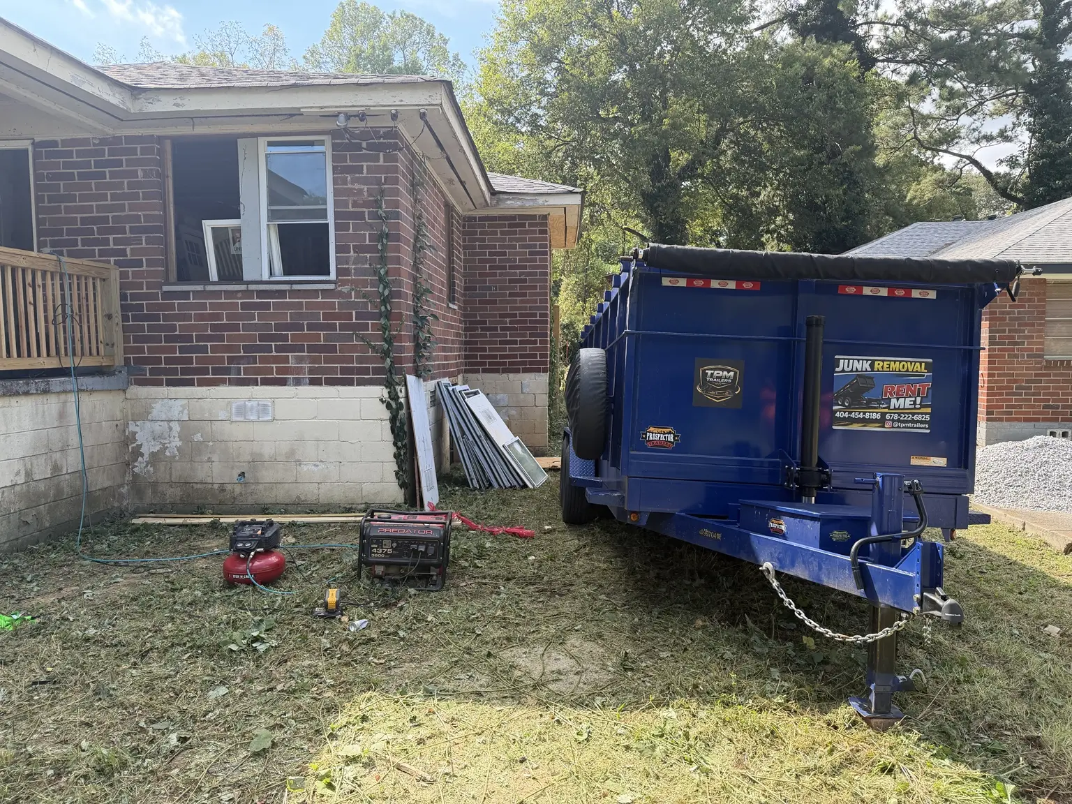 Rear view of TPM 20-yard dump trailer at Atlanta commercial renovation site