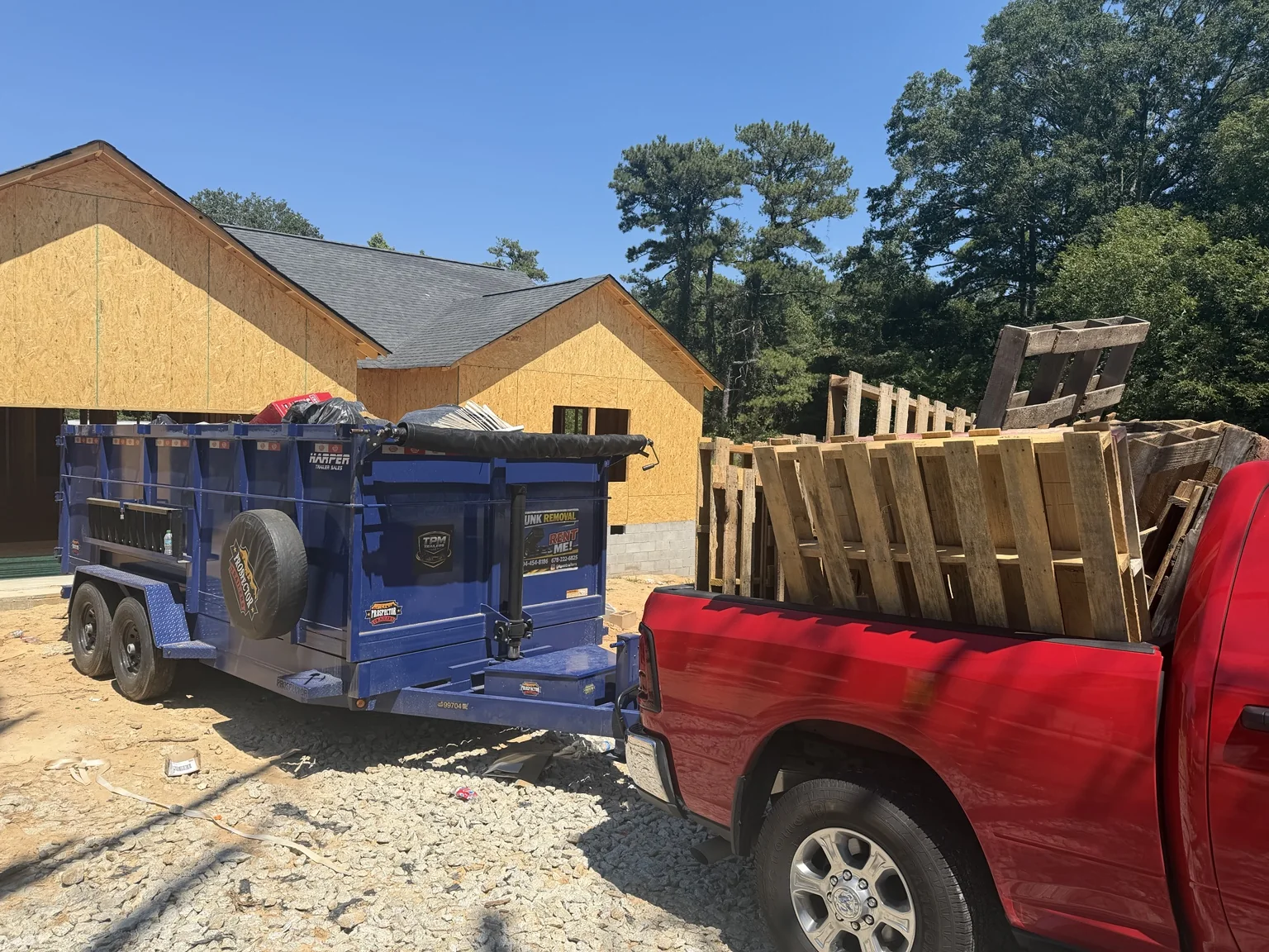 TPM Trailers construction trailer and pickup carrying pallets at a Georgia building site