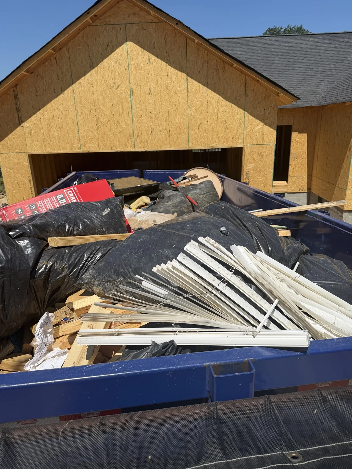 Loaded TPM Trailers dump trailer with wood and construction debris