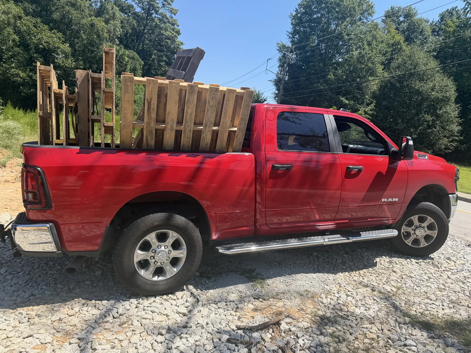 Red heavy-duty pickup loaded with pallets at a Georgia construction site