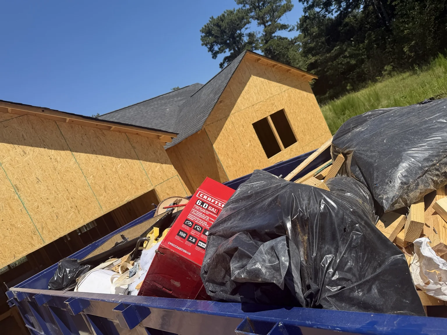Close view of construction debris loaded inside a TPM Trailers dump trailer