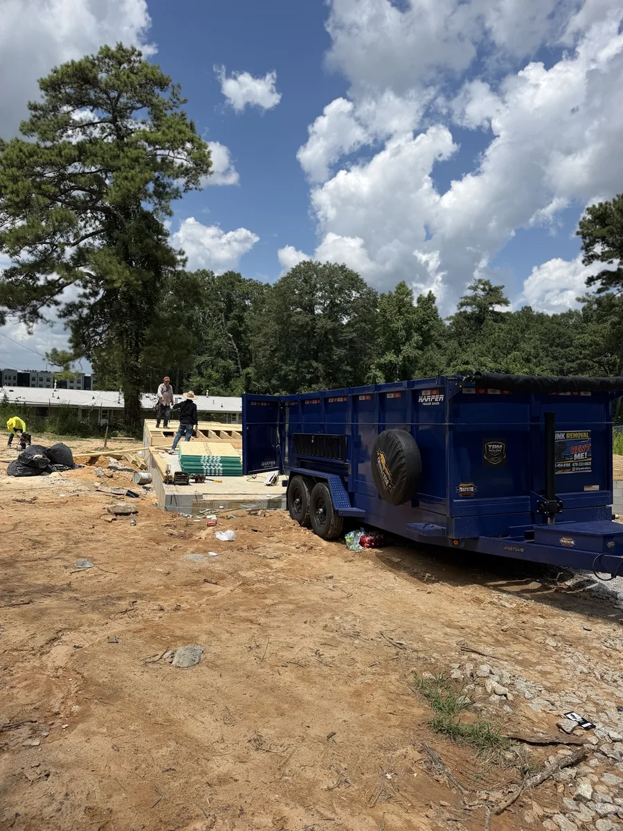 TPM Trailers dump trailer beside framing crews at a Douglasville commercial new construction site