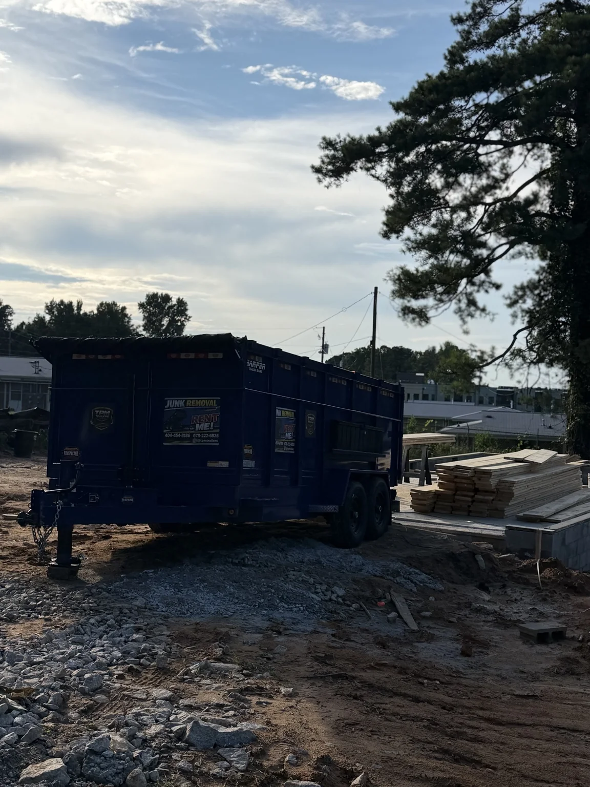 TPM trailer beside lumber at construction site
