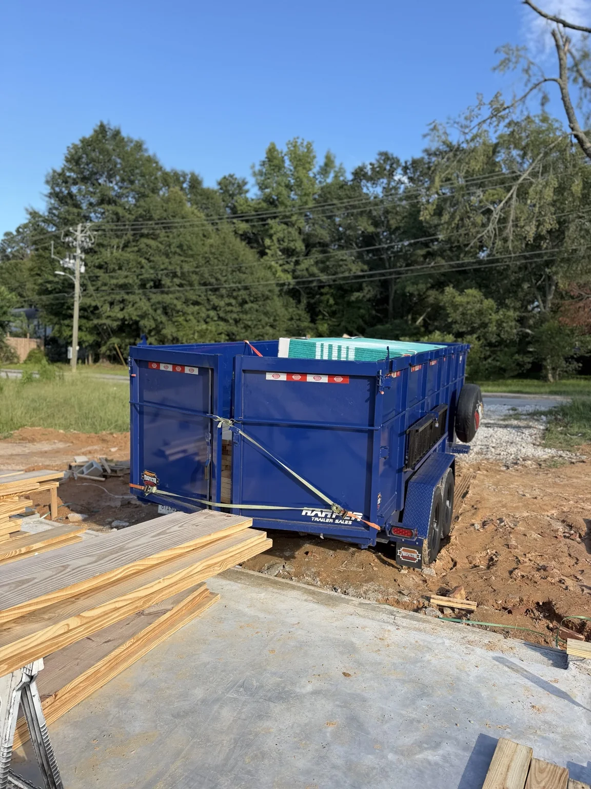 TPM dump trailer with construction materials in Douglasville